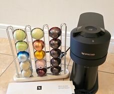 Nespresso Vertuo Next coffee machine with capsule holder and pods to taste