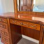 Crafted from stained hardwood with raised drawer panels, rounded pedestal edges, and an arched top mirror crown bordered by heavy metal or wood accent brackets. Nautical Rope Detailing: The upper accent panels on the mirror frame, the top left drawer, and Image 5
