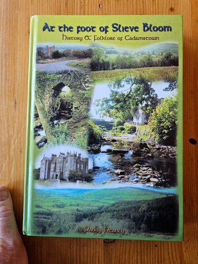 AT The Foot Of The Slieve Bloom. History Of Folklore Of Cadamstown. By Paddy Heaney. First Edition Large Volume Hardback 370 pages In Good Condition.  See Photos For Same.