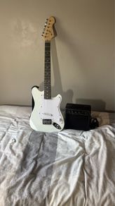 White electric guitar with amp box used only twice