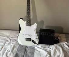 White electric guitar with amp box used only twice