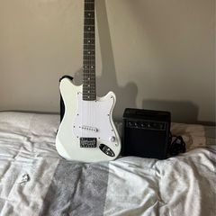 White electric guitar with amp box used only twice