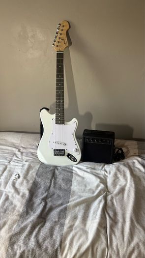 White electric guitar with amp box used only twice