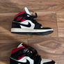 Nike Air Jordan 1 Mid trainers in the classic black, white and red colourway Image 2