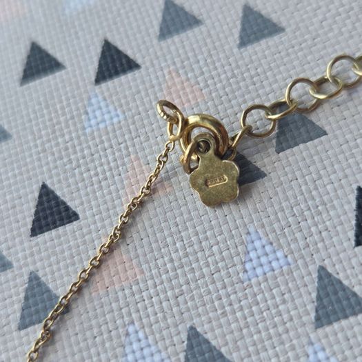 925 sterling silver bracelet with yellow gold plating and V shaped pendant.