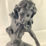 Girl sitting on a dolphin figurine Image 5