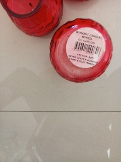 10 candles in red glass holders