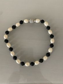 Ivory and black bead necklace with silver clasp