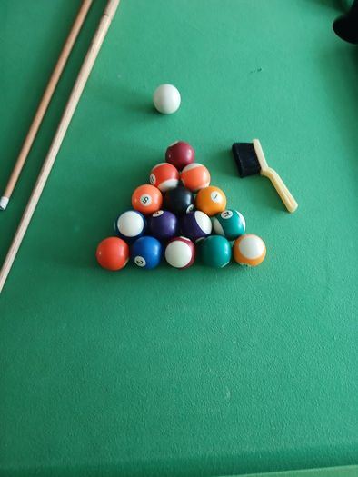 Pool table with cues and balls