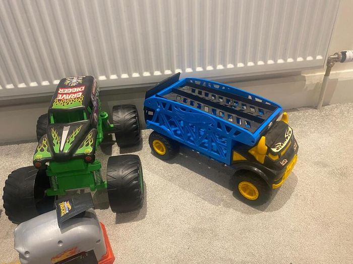 Hot Wheels Monster Trucks collection with transporter and track