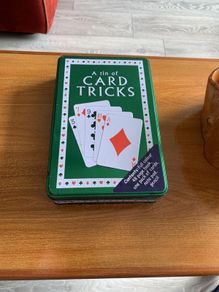 A tin of card tricks set