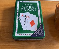 A tin of card tricks set