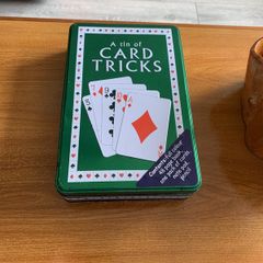 A tin of card tricks set