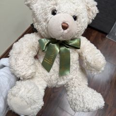 white Harrods teddy bear with a green ribbon.