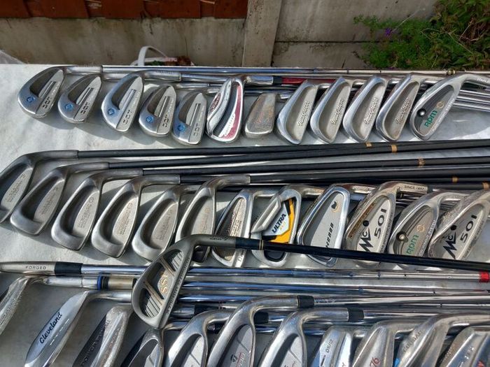 A selection of Golf clubs. Bags and golf balls.
