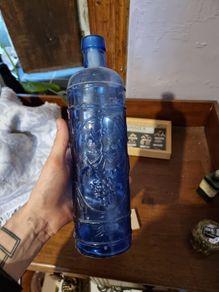 Vintage bottle cobalt blue with grapes