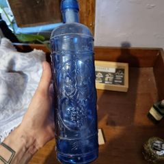 Vintage bottle cobalt blue with grapes