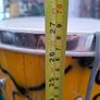 This Tall Bongo Hand Drum, a mechanical bolt tuning system with silver hardware around the top rim. The drum includes a vertical strap mechanism with Bag Image 6