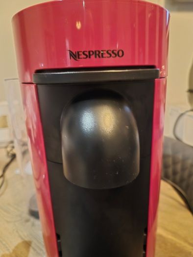 nespresso vertuo plus machine and coffee pods with holding tray