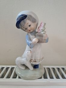 1960s girl with flowers and dog figurine