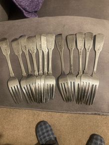 12 Irish sterling forks made by Irish silversmiths in the early 1800s with clear full hallmarks all with the same family crest weighing 820 grams almost 29 ounces