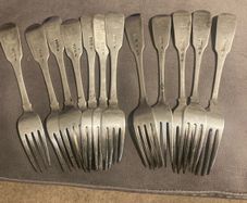 12 Irish sterling forks made by Irish silversmiths in the early 1800s with clear full hallmarks all with the same family crest weighing 820 grams almost 29 ounces