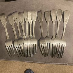 12 Irish sterling forks made by Irish silversmiths in the early 1800s with clear full hallmarks all with the same family crest weighing 820 grams almost 29 ounces