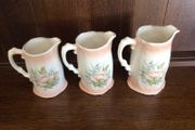 A set of 3 Large Peach Floral porcelain Graduating jugs