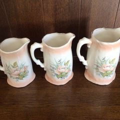 A set of 3 Large Peach Floral porcelain Graduating jugs
