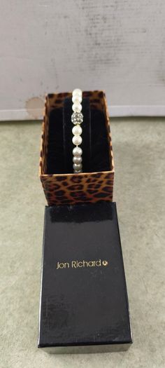 Boxed Jon Richard faux pearl stretch bracelet with a central crystal bead