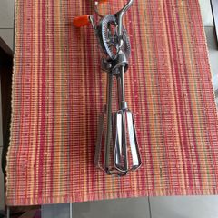 Vintage whisk , steel with orange bakelite handle