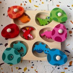 wooden dinosaurs and egg puzzle
