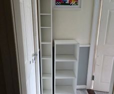 Two white shelving units (bookcase, display, other storage)