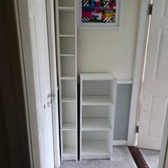 Two white shelving units (bookcase, display, other storage)