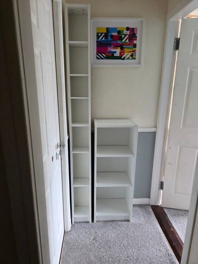 Two white shelving units (bookcase, display, other storage)