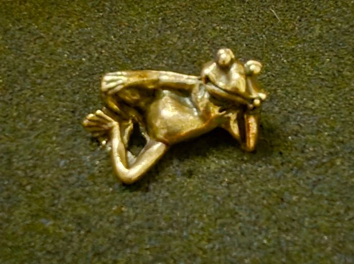 3 brass frogs.