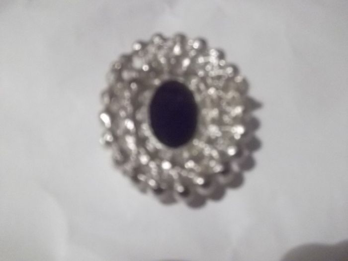 a costome jewelley brooch with cameo and pearls