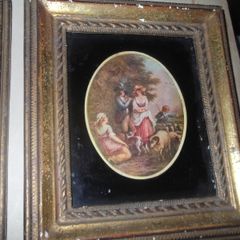 a small antique picture in a gild frame