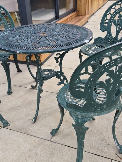 Cast metal garden table and four chairs