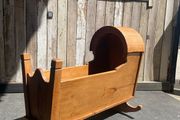 A 19th century style pine baby's rocking cradle.