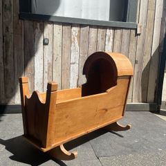 A 19th century style pine baby's rocking cradle.