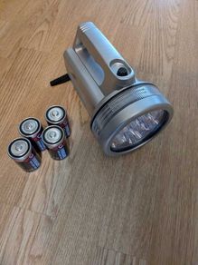 Handheld LED spotlight with batteries