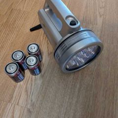 Handheld LED spotlight with batteries