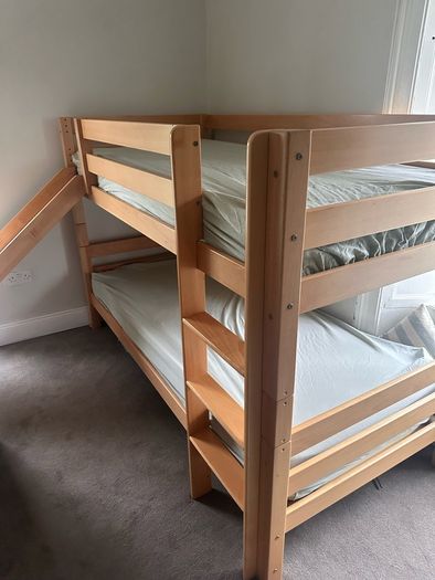 Bunk bed with attached slide and mattresses