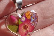 Handcrafted 925 sterling silver necklace with a heart-shaped pendant featuring a floral pattern.