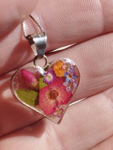 Handcrafted 925 sterling silver necklace with a heart-shaped pendant featuring a floral pattern.