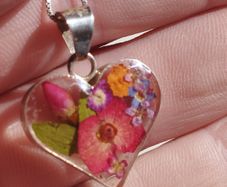 Handcrafted 925 sterling silver necklace with a heart-shaped pendant featuring a floral pattern.