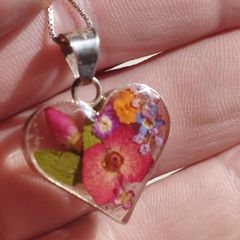 Handcrafted 925 sterling silver necklace with a heart-shaped pendant featuring a floral pattern.