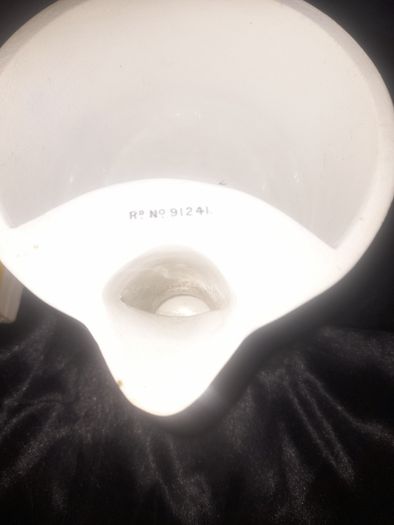 Clarkes Pyramid lamp night light and an Advertisment Box, comprising a white glazed ceramic reservoir marked Prices Patent Candle Company Limited, London