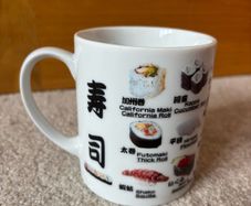 A Mug Featuring Different Types of Sushi
